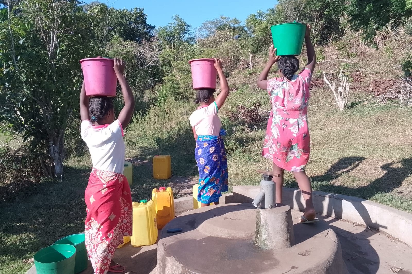 Woman at borehole — field mission